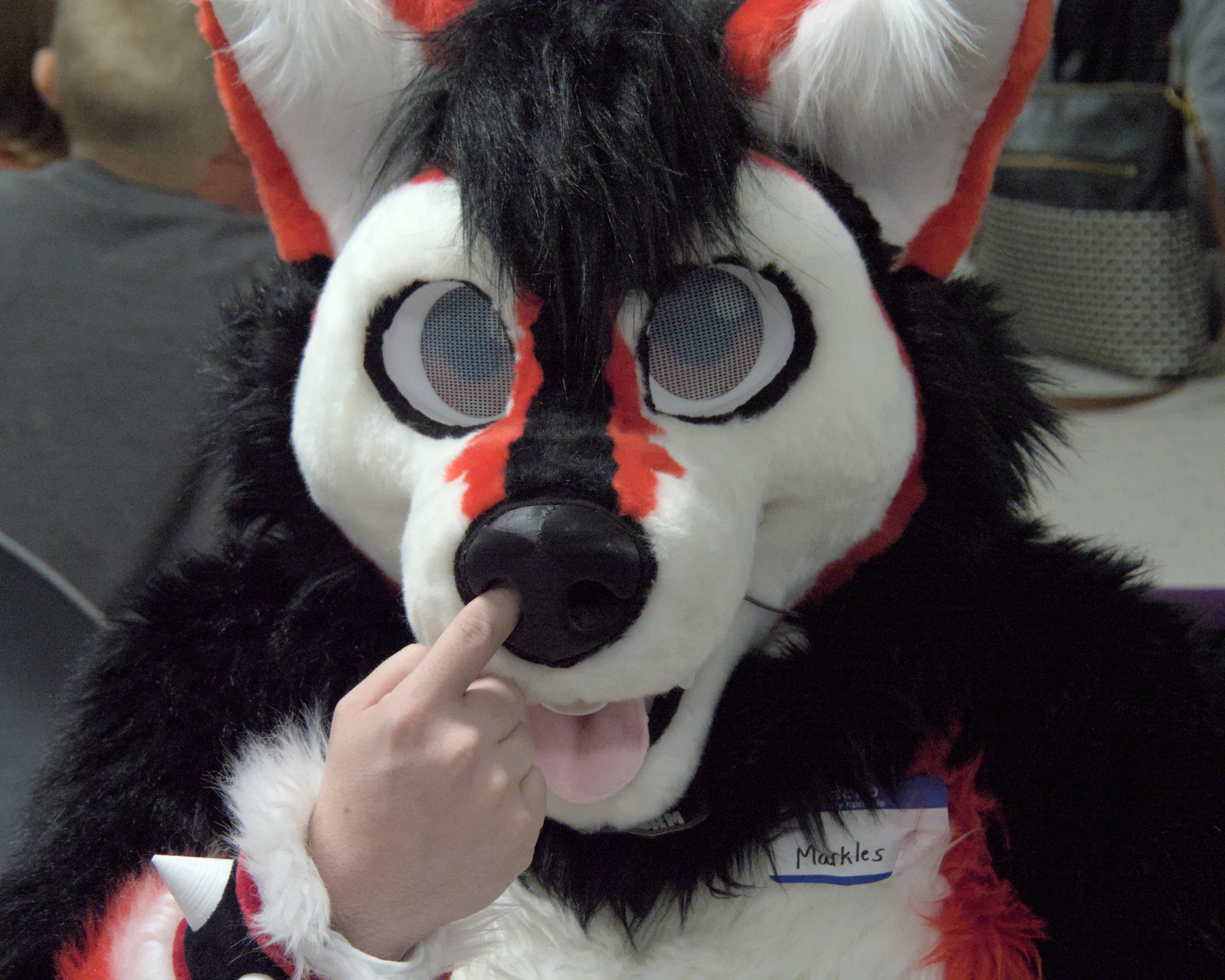 Fursuiter picking his fursuit’s nose with a bare hand